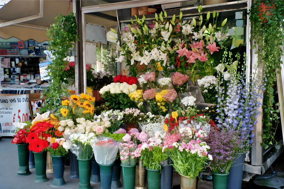 A vibrant display of fresh flowers outside South Croydon Florists near East Croydon Station, featuring a variety of floral arrangements in different colors and styles. The bouquet includes white lilie